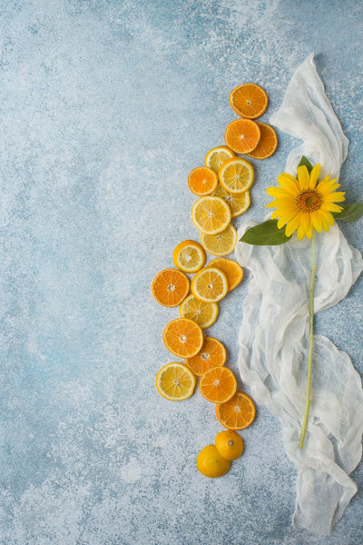 Super-Thin & Pliable Blue Stone Photography Backdrop 2 ft x 3ft, Lightweight, Moisture & Stain-Resistant with oranges and lemons