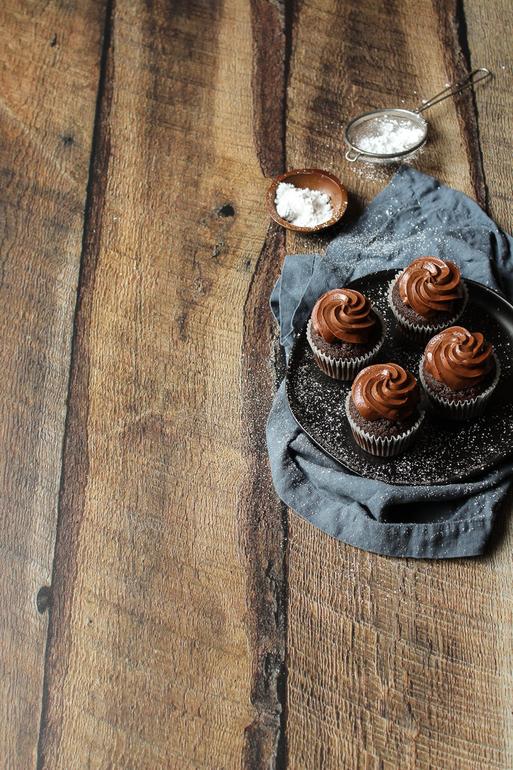 Dark Brown Reclaimed Barn Wood Replica Photography Backdrop 2 ft x 3ft board with chocolate cupcakes on a plate with napkin