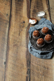 Super-Thin & Pliable Dark Brown Reclaimed Barn Wood Replica Photography Backdrop 2 ft x 3ft, Lightweight, Moisture & Stain-Resistant with chocolate cupcakes on a plate with a blue napkin