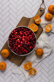 Chevron Tile Replica Photography Backdrop with a bowl of cranberries and oranges on a wooden board