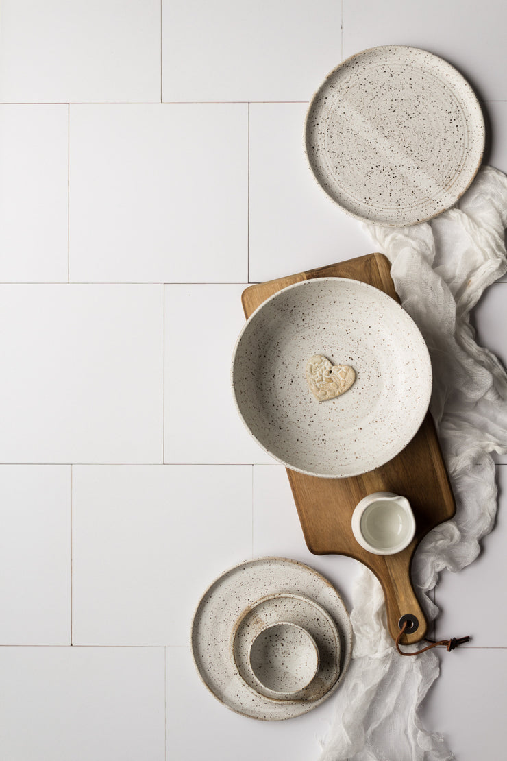 Creamy White Tile Replica Photography Backdrop with white pottery plates and bowls on a wooden board