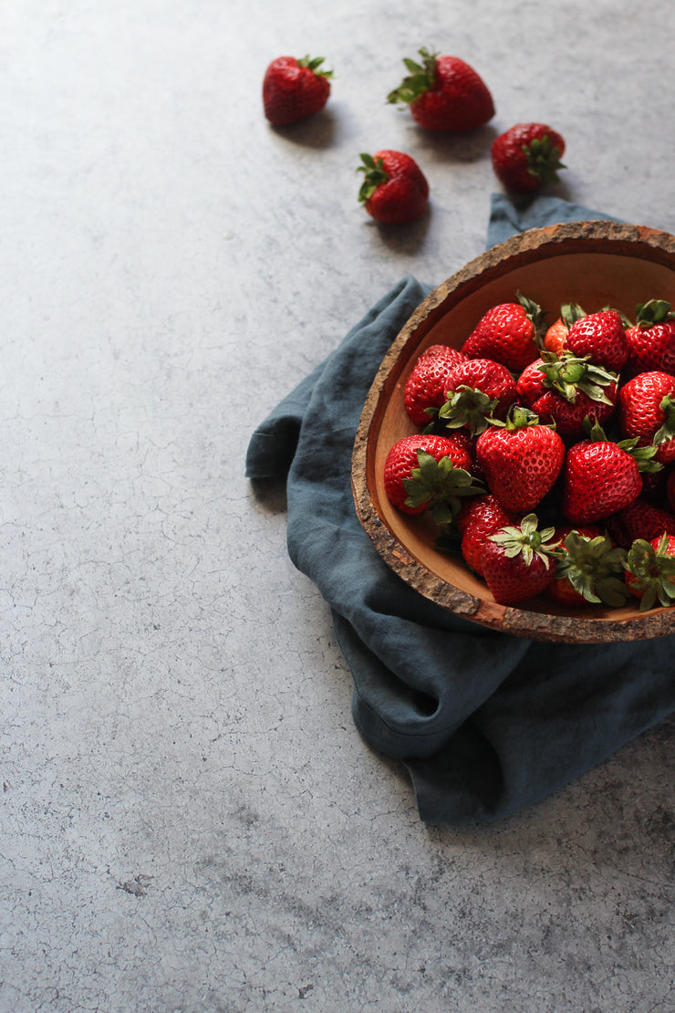 Gray Concrete Photography Backdrop 2 ft x 3 ft | 3 mm thick with strawberries in a bowl on top of linen napkin