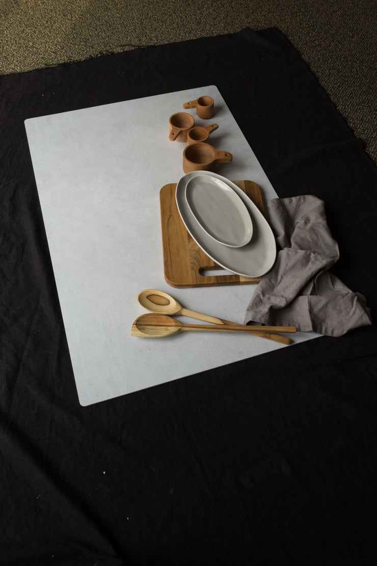 Light Gray Stone Photography Backdrop Board 2 ft x 3 ft | 3 mm thick, Lightweight, Moisture & Stain-Resistant with wooden spoons and cutting board behind the scenes