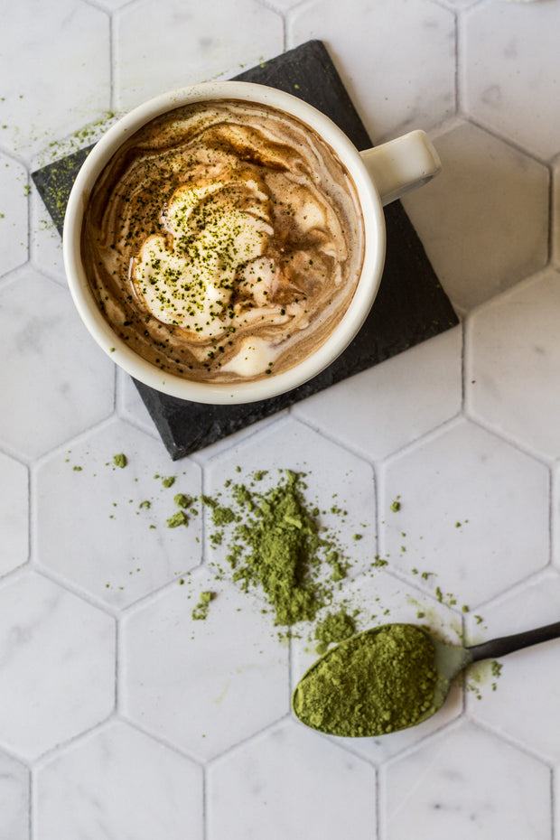 Matcha Hot Chocolate with a spoon of match on a Super-Thin Marble Hexagon Tile Replica Photography Backdrop