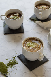 Three cups of matcha hot chocolate on a Super-Thin Marble Hexagon Tile Replica Photography Backdrop