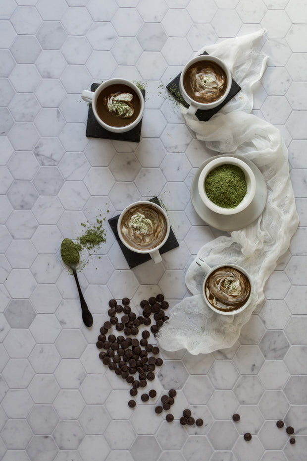 Cups of matcha hot chocolate with matcha tea powder on a Super-Thin Marble Hexagon Tile Replica Photography Backdrop
