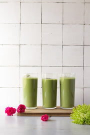 Three green matcha drinks in glasses with a Moroccan Tile Replica Photography Backdrop