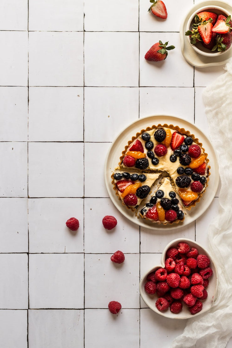 Sliced berry fruit tart on a plate on a Super-thin & pliable Moroccan Tile Replica Photography Backdrop 