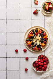 Sliced berry fruit tart on a plate on a Moroccan Tile Replica Photography Backdrop 