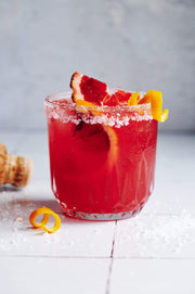 Red drink in a glass with blood oranges on a Moroccan Tile Replica Photography Backdrop 