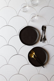 Black plates and black forks and spoons on a Super-Thin & Pliable Scalloped Tiles Replica Photography Backdrop