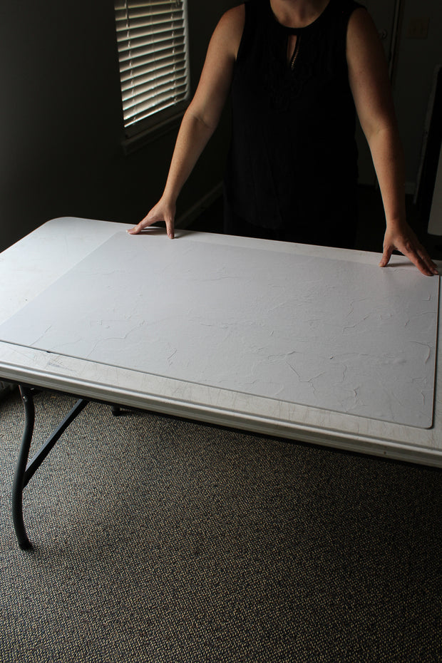 Simple White Textured Photography Backdrop 2 ft x 3 ft board with a person holding it