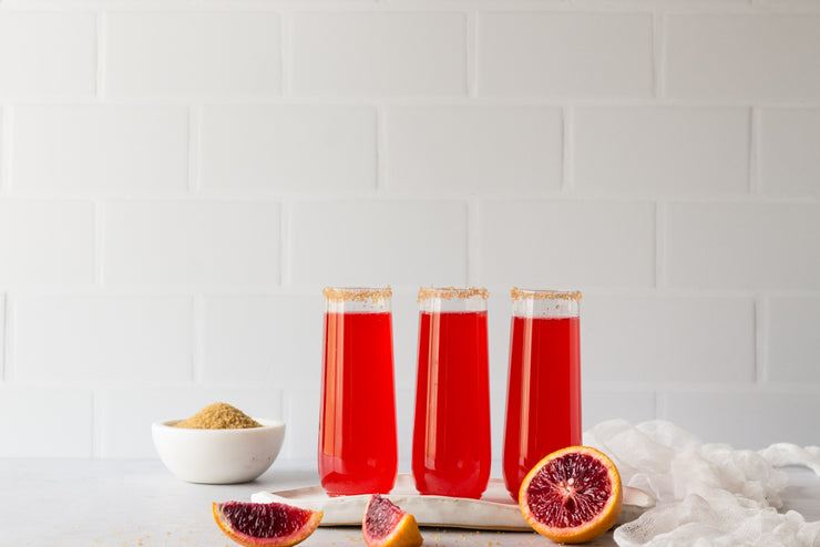 Subway Tile with White Grout Photography Backdrop  with three red sparkling drinks and blood oranges