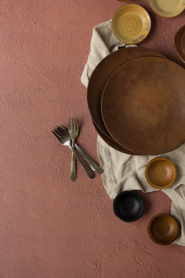 Terra Cotta Photography Backdrop 2 ft x 3ft board with brown plates and bowls up close