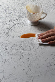 White Plaster Photography Backdrop 2 ft x 3 ft | 3 mm thick with a spill being wiped clean