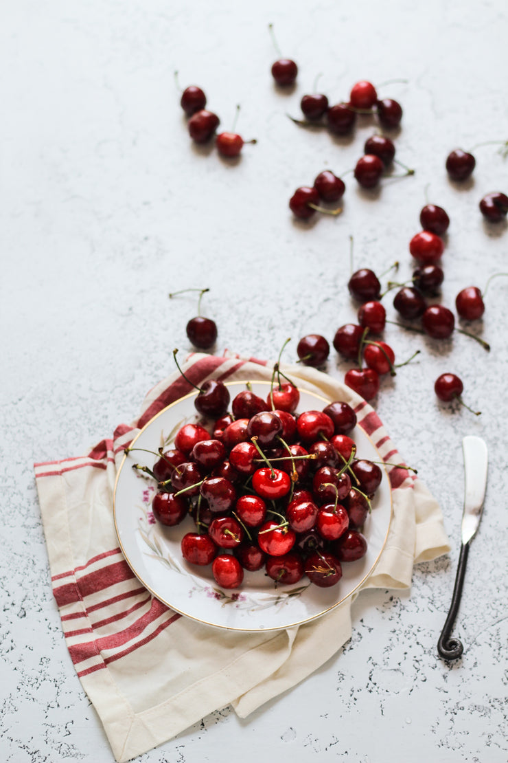 White Plaster Photography Backdrop 2 ft x 3 ft | 3 mm thick with a plate of cherries