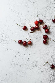 Super-Thin & Pliable White Plaster Photography Backdrop 2 ft x 3 ft, Lightweight, Moisture & Stain-Resistant and cherries up close